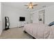 Comfortable bedroom with neutral tones, ceiling fan, and view of the closet at 18854 W Poinsettia Dr, Surprise, AZ 85388