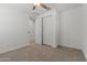 Bedroom with empty floorspace and mirrored closet doors at 18854 W Poinsettia Dr, Surprise, AZ 85388