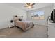 Relaxing bedroom features a cozy bed, nightstand, and a bright window with natural light at 18854 W Poinsettia Dr, Surprise, AZ 85388