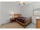 Comfortable bedroom with a ceiling fan, a cozy bed, and a bedside table at 18854 W Poinsettia Dr, Surprise, AZ 85388