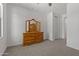 Spacious bedroom with wooden dresser and three-part mirror at 18854 W Poinsettia Dr, Surprise, AZ 85388