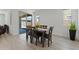 Cozy dining room features a table for six and sliding glass doors leading to the backyard at 18854 W Poinsettia Dr, Surprise, AZ 85388
