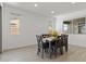 Bright dining area with a table and seating for six, illuminated by recessed lighting at 18854 W Poinsettia Dr, Surprise, AZ 85388