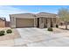 Well-maintained single-story home featuring a two-car garage and low-maintenance landscaping at 18854 W Poinsettia Dr, Surprise, AZ 85388