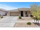 Charming single-story home with stone accents, low maintenance front yard, and two-car garage at 18854 W Poinsettia Dr, Surprise, AZ 85388