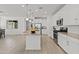 Modern kitchen with stainless steel appliances, a central island, and sleek white cabinets at 18854 W Poinsettia Dr, Surprise, AZ 85388