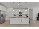 Bright kitchen featuring an island, modern lighting, and stainless steel appliances at 18854 W Poinsettia Dr, Surprise, AZ 85388