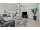 Bright, open living room with plush seating, ceiling fan, and open access to the kitchen at 18854 W Poinsettia Dr, Surprise, AZ 85388