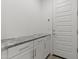 Bright mudroom boasts modern cabinets, beautiful countertops, and ample storage at 18854 W Poinsettia Dr, Surprise, AZ 85388