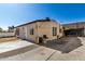 Exterior rear view of cozy home and newly graveled drive, providing ample parking space at 1916 W Tonto St, Phoenix, AZ 85009