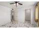 Bright bedroom featuring neutral walls and tile floors with multiple entries to other rooms at 1916 W Tonto St, Phoenix, AZ 85009