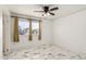 Cozy bedroom with updated flooring, a ceiling fan, and a bright window with street views at 1916 W Tonto St, Phoenix, AZ 85009