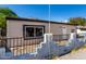 Side view of a single-story home showcasing a secure fenced yard and updated windows at 1916 W Tonto St, Phoenix, AZ 85009