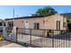 Single-story home with a fenced front yard and clear blue sky, ready for comfortable living at 1916 W Tonto St, Phoenix, AZ 85009