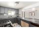 Well-lit kitchen featuring stylish gray cabinets, tile backsplash, and a convenient pass-through to the living area at 1916 W Tonto St, Phoenix, AZ 85009
