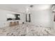 Spacious living room boasts modern tile flooring and open bar-style seating to the kitchen at 1916 W Tonto St, Phoenix, AZ 85009