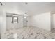 Bright living room with neutral paint, modern tile floors, and a window AC unit for added comfort at 1916 W Tonto St, Phoenix, AZ 85009