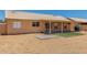 Desert landscaped backyard with covered patio, artificial turf, and stepping stone at 19802 N 3Rd Ave, Phoenix, AZ 85027