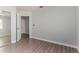 Neutral bedroom featuring wood-look floors and a double door closet at 19802 N 3Rd Ave, Phoenix, AZ 85027