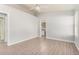 Neutral bedroom with wood-look floors, ceiling fan, and an ensuite bathroom at 19802 N 3Rd Ave, Phoenix, AZ 85027