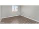 Cozy bedroom features wood-look flooring and natural light at 19802 N 3Rd Ave, Phoenix, AZ 85027
