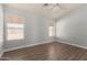 Well-lit bedroom with wood-look flooring, a ceiling fan, and bright natural light at 19802 N 3Rd Ave, Phoenix, AZ 85027