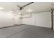 Spacious garage with epoxy floor and overhead storage, ready for vehicles and projects at 19802 N 3Rd Ave, Phoenix, AZ 85027
