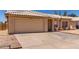 Front exterior view of the property featuring a large garage, desert landscaping, and red tile roof at 19802 N 3Rd Ave, Phoenix, AZ 85027