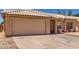 Front exterior view of the property featuring a large garage, desert landscaping, and red tile roof at 19802 N 3Rd Ave, Phoenix, AZ 85027