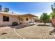 This backyard has a covered patio, drought resistant landscaping, and mature trees at 2018 W Taro Ln, Phoenix, AZ 85027