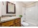 Bathroom with granite vanity, matching mirror, and shower-tub combo at 2018 W Taro Ln, Phoenix, AZ 85027