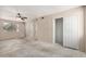 Spacious bedroom with ceiling fan, closet space, and natural light from a window at 2018 W Taro Ln, Phoenix, AZ 85027