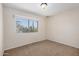 A bright bedroom with a large window and views of the desert landscape at 2018 W Taro Ln, Phoenix, AZ 85027