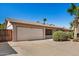 Single-story home showcasing a spacious two-car garage and easy-care landscaping at 2018 W Taro Ln, Phoenix, AZ 85027