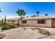 Charming home with desert landscaping, including palm trees and cacti, offering curb appeal at 2018 W Taro Ln, Phoenix, AZ 85027