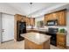 Charming kitchen features wood cabinets, granite countertops, and black appliances at 2018 W Taro Ln, Phoenix, AZ 85027