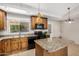Well-lit kitchen with wood cabinets, granite countertops, and modern appliances at 2018 W Taro Ln, Phoenix, AZ 85027