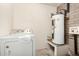 Laundry room with modern washer and water heater at 2018 W Taro Ln, Phoenix, AZ 85027