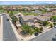 Aerial view of home showcases its large backyard, paved patio, landscaping, and neighborhood at 20198 E Rosa Rd, Queen Creek, AZ 85142
