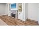 Cozy basement featuring a brick fireplace, built-in shelving, and wood-style flooring at 20198 E Rosa Rd, Queen Creek, AZ 85142