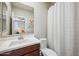 Bathroom features a modern sink and vanity, toilet, and a shower with a white shower curtain at 20198 E Rosa Rd, Queen Creek, AZ 85142