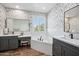 Elegant bathroom with dual vanities, soaking tub, and stylish wallpaper at 20198 E Rosa Rd, Queen Creek, AZ 85142