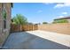 Spacious concrete driveway with a wood gate, set against a clear blue sky at 20198 E Rosa Rd, Queen Creek, AZ 85142