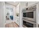 Modern kitchen featuring stainless steel appliances, white cabinets, and wood flooring at 20198 E Rosa Rd, Queen Creek, AZ 85142