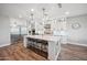 Modern kitchen with a large island, pendant lighting, and stainless steel appliances at 20198 E Rosa Rd, Queen Creek, AZ 85142