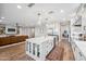 Bright, open kitchen with island seating, farmhouse sink, and access to living area at 20198 E Rosa Rd, Queen Creek, AZ 85142