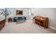 Stylish living room featuring a piano, blue velvet couch, and carpeted floors at 20198 E Rosa Rd, Queen Creek, AZ 85142