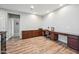 Spacious office area features custom built-ins and wood-look flooring, offering a functional workspace at 20198 E Rosa Rd, Queen Creek, AZ 85142