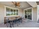 Covered outdoor dining area with a wooden table, chairs, and a built-in bench, perfect for entertaining at 20198 E Rosa Rd, Queen Creek, AZ 85142