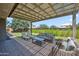 Relaxing outdoor patio with comfortable seating, a coffee table, and a pergola, ideal for lounging at 20198 E Rosa Rd, Queen Creek, AZ 85142